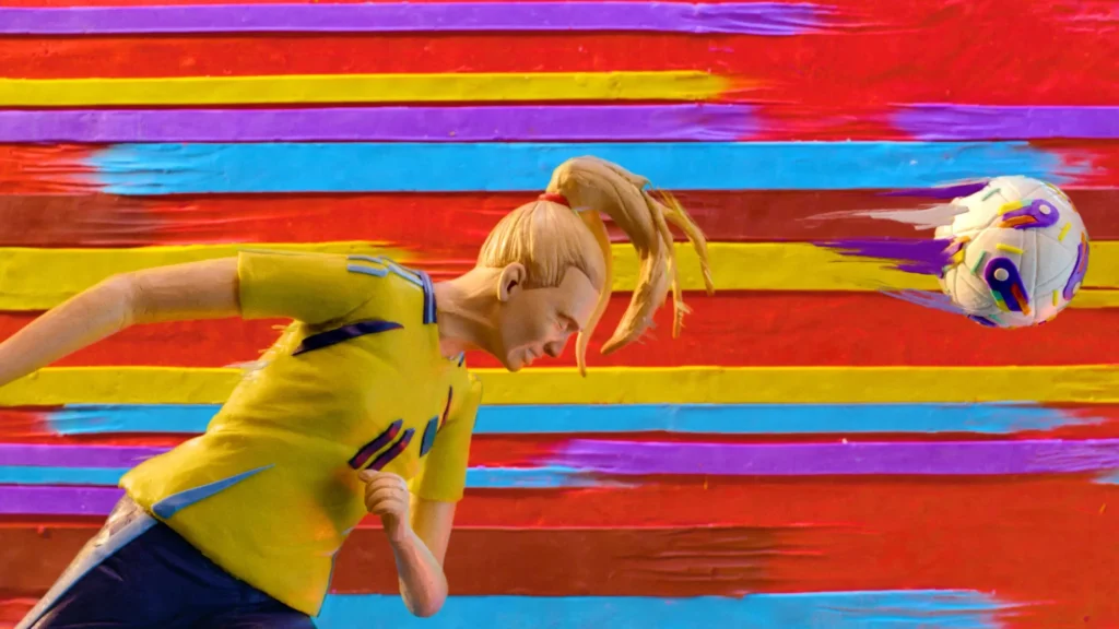 Female footballer kicking a vibrant ball.