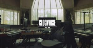 A professional music and film editing suite featuring keyboards and studio monitors, branded for Clockwise Film, a leader in social media video production in the UK.
