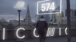 A man standing on a London rooftop overlooking the city skyline with New Balance 574 AR graphics, created by Maverick Studio for social media video production in the UK.